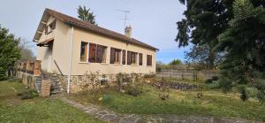 a small house in a field next to a building at La cherpée in Lhommaizé