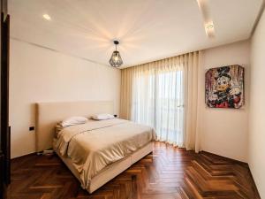 a bedroom with a bed and a large window at CFC Casablanca - Luxury 1-Bedroom Apartment with Anfa Park View in Casablanca