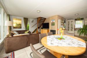 a living room with a table and a couch at Ferienhaus Sonnenschein in Sint Maarten