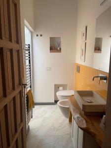 a bathroom with a toilet and a sink at Ca Lillá in Florence +9 photos