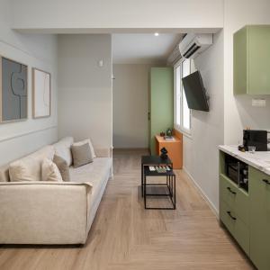a living room with a couch and a table at ASTIKON Xenofontos Suites in Athens
