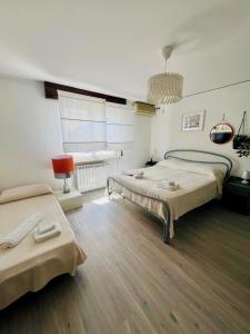 a large room with two beds and a window at Fil Rouge in Ciampino +100 photos