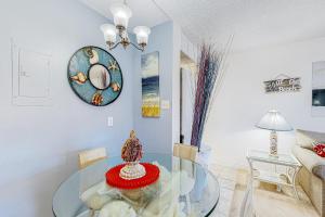 a dining room with a glass table in a room at Bluewater East 407 S in Ocean City +10 photos