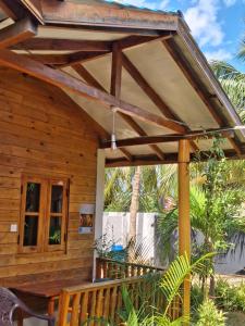a wooden pergola over a porch of a house at Bashi eco beach cabana in Trincomalee