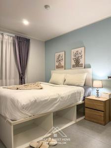 a bedroom with a large bed with white sheets at Condo for rent by phuket sweet home chalong in Ban Klang
