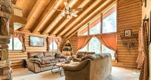 a living room with leather furniture in a log cabin at Cozy three bedroom cabin in Duck Creek in Duck Creek Village