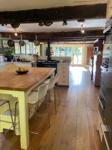 a kitchen with a large wooden table and chairs at Bartley Mill in Wadhurst