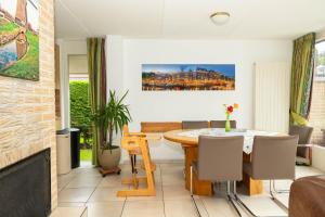 a dining room with a table and chairs at Ferienhaus Sonnenschein in Sint Maarten +43 photos