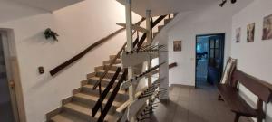 a staircase in a house with a wooden railing at Gościniec, kwatery prywatne przy stoku w Zieleńcu in Duszniki Zdrój