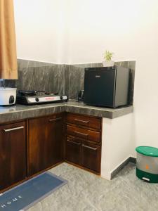 a kitchen with a counter top with a tv on it at Hiriketiya Green Haven Villa in Dickwella