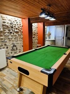 a pool table in a room with a green cloth at Villa Garona avec billard proche Pyrénées in Cazères