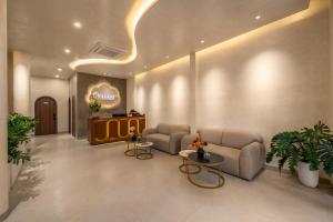 a lobby with two couches and tables in a building at Bullani-Sabi Hotel & Apartment in Da Nang +38 photos
