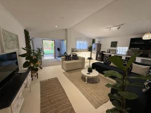 a living room with a couch and a table at Lemón Phoenix in Bela-Bela