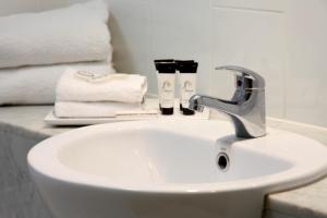 a white bathroom sink with a faucet and towels at Brisbane International Virginia in Brisbane +40 photos