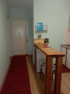 a small kitchen with a wooden table in a room at GUESTHOUSE TARA in Kolašin