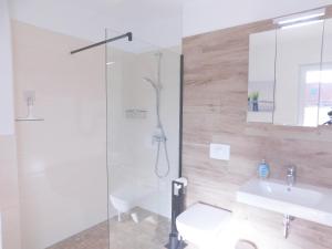 a bathroom with a shower and a sink at FeWo "Hafenblick" in Barth +25 photos