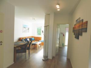 a living room and dining room with a table and chairs at FeWo "Hafenblick" in Barth