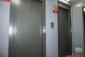 a row of elevator doors in a building at Holidays Rincón Vista Mar PL4 in Empuriabrava