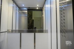 a glass elevator with a mirror in a building at Holidays Rincón Vista Mar PL4 in Empuriabrava +9 photos