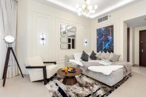 a living room with a couch and a table at Desert Key Luxury Apt with Seaview, Saadiyat Island in Abu Dhabi