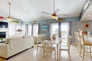 a living room with a white couch and a table at Seas the Day in Port Aransas