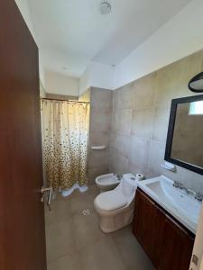 a bathroom with a toilet and a sink at Sampa Pacha - Cabaña 3 in Villa Parque Siquiman