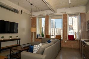 Una sala de estar con un sofá y un televisor de pantalla plana. en Dallas Loft, en Dallas
