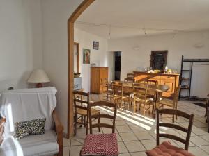 a living room with a table and chairs at Au Diapason Chambres d'hôtes montagne in Auzet