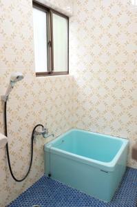 a bath tub in a bathroom with a window at Forest villa lake yamanaka in Wada +36 photos