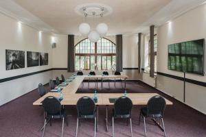 a conference room with a long table and chairs at Parkschlösschen Lichtenstein Sachsen in Lichtenstein
