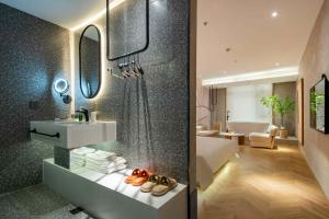 a bathroom with a sink and a mirror at Qiyu Hotel - Xian Bell Tower in Xi'an +45 photos