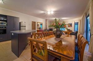 a kitchen and dining room with a table and chairs at Yallingup Pet Friendly Bush Retreat in Yallingup