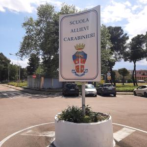 a sign for a car dealership in a parking lot at Casa vacanze Rubino in Taranto
