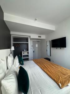 a bedroom with a large bed and a flat screen tv at Best Western Blois Château in Blois