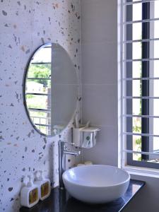 a bathroom with a white sink and a mirror at Nắng Homestay Huế in Hue
