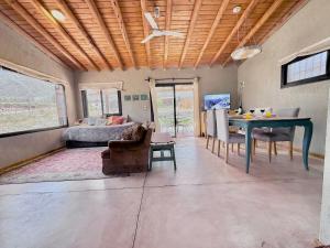 a living room with a table and a couch at Wabi sabi, casita de montaña con pileta in Mendoza