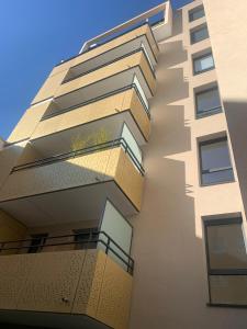 a tall building with balconies on the side of it at Malakoff - 3 pièces avec terrasse in Malakoff
