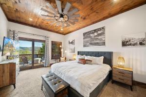 a bedroom with a large bed and a wooden ceiling at Cranberry View Lodge in Newland