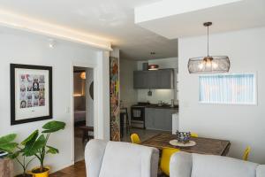 a kitchen and living room with a table and chairs at Trelew View in Trelew