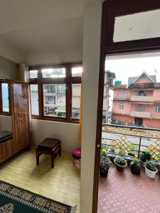 a room with a window and a view of a building at Shenga Homestay in Ravangla