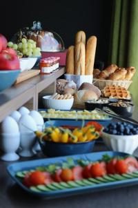 a table topped with lots of different types of food at VISIONAPARTMENTS Lugano -self check-in in Lugano