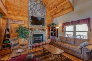 a living room with a couch and a stone fireplace at New River Ramble in Todd +56 photos