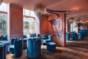 a room with blue chairs and a painting on the wall at VISIONAPARTMENTS Lugano -self check-in in Lugano