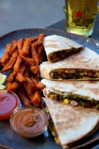 a plate of food with a sandwich and french fries at VISIONAPARTMENTS Lugano -self check-in in Lugano +27 photos