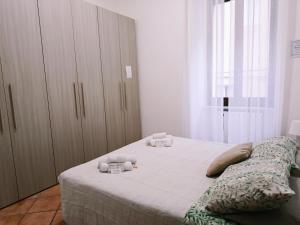 a bedroom with a bed with two candles on it at Paradise Home Centro Storico Ascoli Piceno in Ascoli Piceno +9 photos