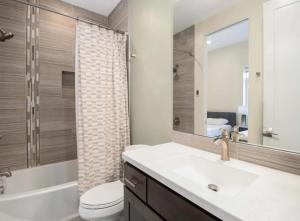 a bathroom with a sink and a toilet and a mirror at Modern Mountain Retreat Single Level Living in Glenwood Springs +4 photos