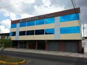 a building with a sign on the side of it at Hotel Carrizal Suites in Barinas