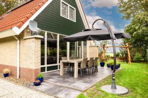 a patio with a table and an umbrella at Ferienhaus Weitblick in Sint Maarten