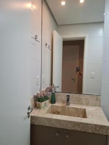 a bathroom with a sink and a large mirror at NOVO e DECORADO no Centro de Canela! in Canela +33 photos