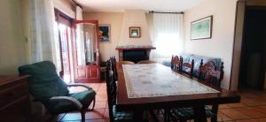 a dining room with a table and chairs and a fireplace at La Casa Maria in Pego